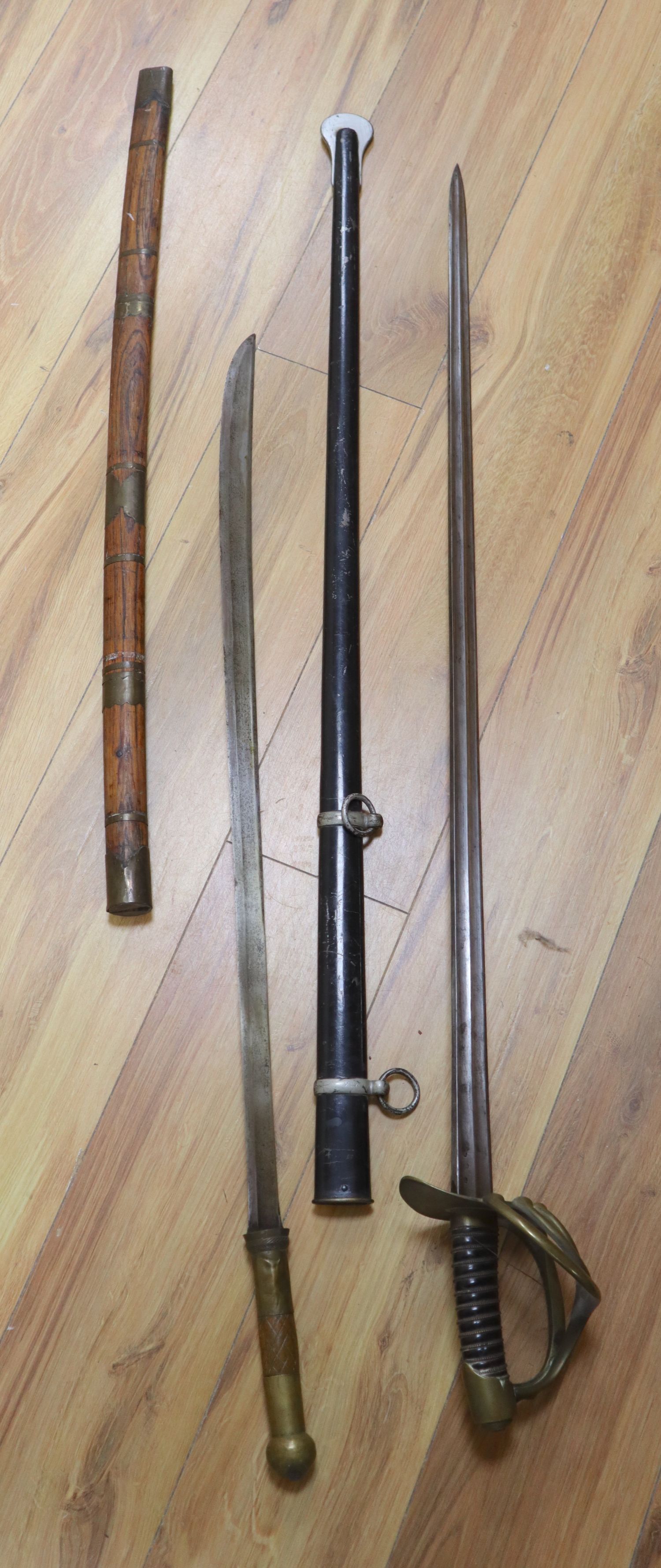 A French Cuirassier sword, blade 93cm, together with an Eastern brass mounted sword with wooden scabbard